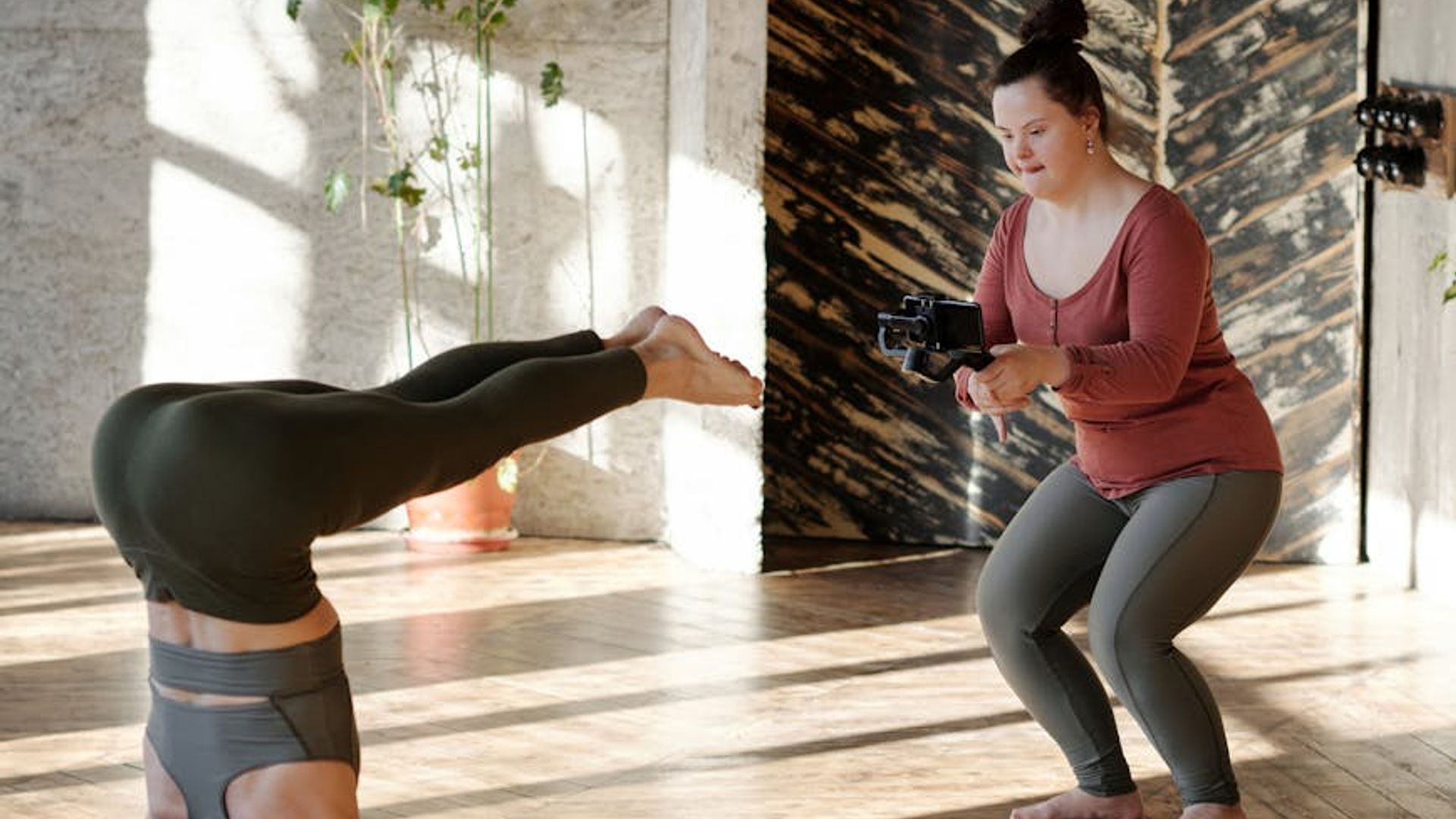 Bright yoga studio with sunlight and natural wooden floors.